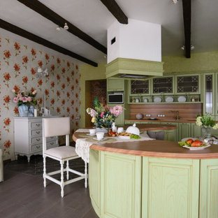 Inspiration for a mid-sized traditional l-shaped open plan kitchen in Novosibirsk with an undermount sink, raised-panel cabinets, green cabinets, wood benchtops, brown splashback, timber splashback, panelled appliances, with island, brown floor, brown benchtop and wallpaper.