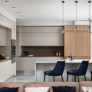 Contemporary open plan kitchen in Moscow with flat-panel cabinets, beige cabinets, brown splashback, a peninsula, white floor and brown benchtop.