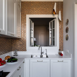 Inspiration for a mid-sized transitional l-shaped separate kitchen in Moscow with an undermount sink, raised-panel cabinets, white cabinets, solid surface benchtops, yellow splashback, mosaic tile splashback, stainless steel appliances, laminate floors, beige floor and white benchtop.