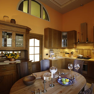 Country u-shaped eat-in kitchen in Saint Petersburg with an undermount sink, flat-panel cabinets, brown cabinets, solid surface benchtops, yellow splashback, stainless steel appliances, porcelain floors, beige floor and yellow benchtop.