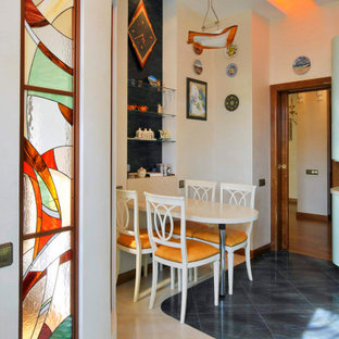 This is an example of a mid-sized contemporary eat-in kitchen in Moscow with an undermount sink, flat-panel cabinets, solid surface benchtops, green splashback, porcelain splashback, stainless steel appliances, porcelain floors, green floor and grey benchtop.
