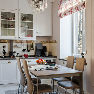 Inspiration for a small traditional single-wall eat-in kitchen in Moscow with glass-front cabinets, white cabinets, quartz benchtops, beige splashback, ceramic splashback, stainless steel appliances, ceramic floors, grey benchtop, no island and multi-coloured floor.