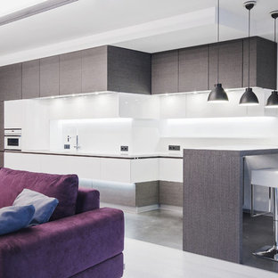 Photo of a large contemporary single-wall eat-in kitchen in Moscow with flat-panel cabinets, grey cabinets, white splashback, an undermount sink, solid surface benchtops, marble splashback, panelled appliances, porcelain floors and grey floor.