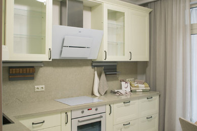 This is an example of a medium sized contemporary l-shaped kitchen/diner in Moscow with a submerged sink, recessed-panel cabinets, white cabinets, engineered stone countertops, beige splashback, marble splashback, white appliances, porcelain flooring, no island, beige floors and beige worktops.