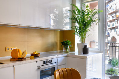 This is an example of a small contemporary l-shaped enclosed kitchen in Moscow with a submerged sink, white cabinets, composite countertops, yellow splashback, white appliances, porcelain flooring, no island, grey floors, flat-panel cabinets and white worktops.
