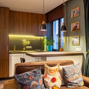 Small scandinavian single-wall open plan kitchen in Moscow with a drop-in sink, flat-panel cabinets, black splashback, porcelain splashback, white appliances, vinyl floors, with island, brown floor and brown benchtop.