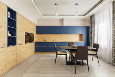 Inspiration for a contemporary l-shaped kitchen/diner in Moscow with flat-panel cabinets, blue cabinets, beige splashback, wood splashback, no island, beige floors, beige worktops and stainless steel appliances.