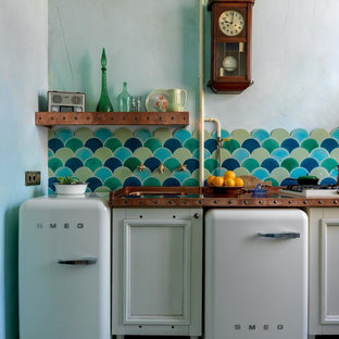 Design ideas for a small eclectic single-wall eat-in kitchen in Moscow with a single-bowl sink, recessed-panel cabinets, white cabinets, copper benchtops, multi-coloured splashback, ceramic splashback, white appliances, ceramic floors, multi-coloured floor and orange benchtop.