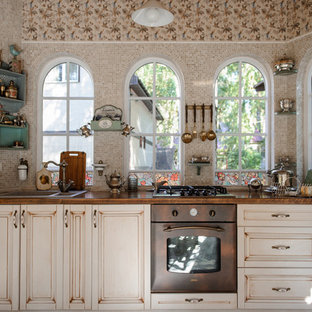 This is an example of a small shabby-chic style single-wall eat-in kitchen in Novosibirsk with beige cabinets, beige splashback, no island, a drop-in sink, raised-panel cabinets, mosaic tile splashback and coloured appliances.