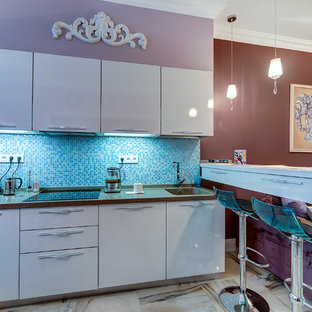 This is an example of a contemporary l-shaped open plan kitchen in Saint Petersburg with an integrated sink, flat-panel cabinets, white cabinets, mosaic tile splashback, porcelain floors and a peninsula.