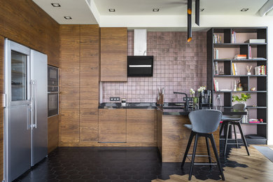 Inspiration for a contemporary u-shaped kitchen in Moscow with a submerged sink, flat-panel cabinets, medium wood cabinets, pink splashback, black appliances, a breakfast bar, black floors and black worktops.