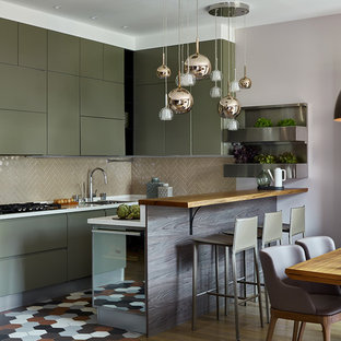 Design ideas for a mid-sized contemporary u-shaped eat-in kitchen in Moscow with a single-bowl sink, flat-panel cabinets, green cabinets, solid surface benchtops, ceramic splashback, porcelain floors, multi-coloured floor, white benchtop, beige splashback, black appliances and a peninsula.