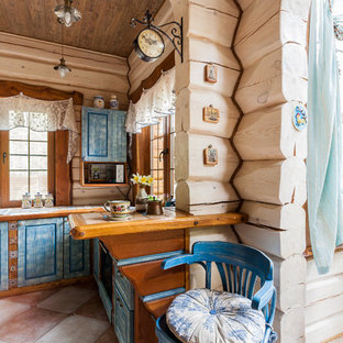 Foto de cocina en U, romántica, con fregadero encastrado, armarios con paneles con relieve, puertas de armario azules, encimera de azulejos y península