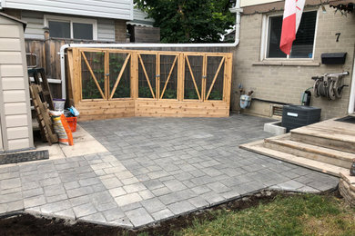 This is an example of a mid-sized partial sun front yard concrete paver vegetable garden landscape in Toronto for summer.