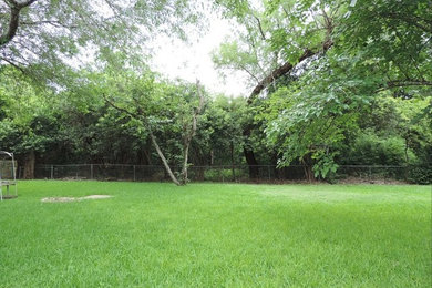 Photo of a large southwestern backyard landscaping in Austin.