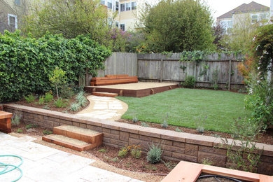 Photo of a large contemporary back fully shaded garden in San Francisco with a retaining wall and concrete paving.
