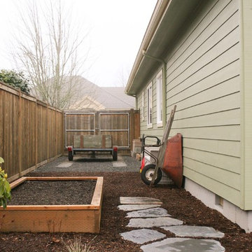 A hollywood driveway for trailer storage along the side of the home.