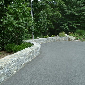 A stone wall encloses the parking area