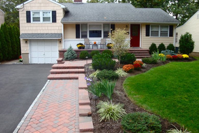 Photo of a transitional partial sun front yard concrete paver landscaping in New York.