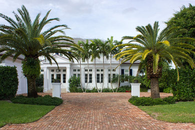 This is an example of a small traditional front yard brick driveway in Miami.
