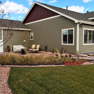 Design ideas for a mid-sized craftsman partial sun backyard stone landscaping in Other with a fire pit for summer.