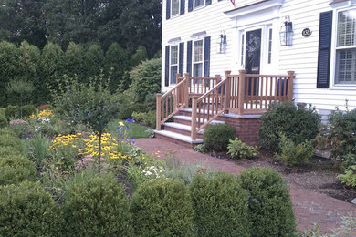 Medium sized classic front formal garden in Boston with a garden path and brick paving.