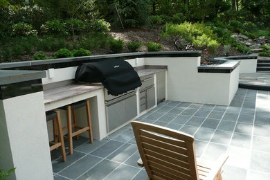 Large back full sun garden in Richmond with natural stone paving.