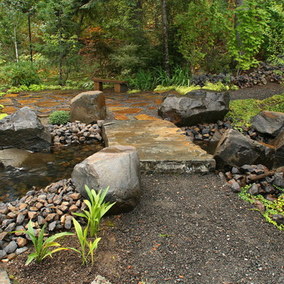 Inspiration for a traditional backyard gravel water fountain landscape in Seattle.