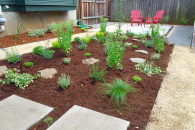 This is an example of a small contemporary drought-tolerant and full sun backyard concrete paver landscaping in Portland.