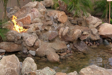 This is an example of a mid-sized traditional backyard water fountain landscape in Phoenix.