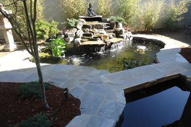 Design ideas for an eclectic side yard stone water fountain landscape in Los Angeles.