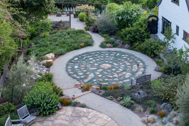 Photo of a large contemporary drought-tolerant and full sun backyard stone landscaping in San Francisco with a fire pit for spring.