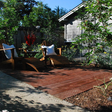 An at-grade deck offers a space to lounge amid a grove of 'Pink Lady' apple tree
