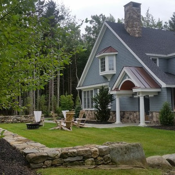 An extensive landscape project with stonewalls, patio, dry river bed & more