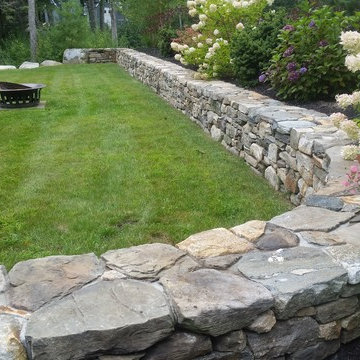 An extensive landscape project with stonewalls, patio, dry river bed & more