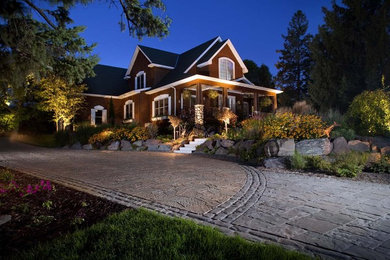 Inspiration for a mid-sized traditional front yard concrete paver landscaping in Minneapolis for summer.