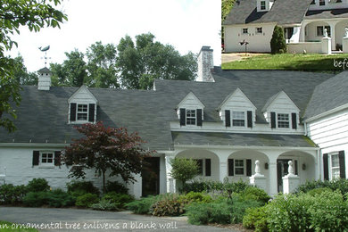 Photo of a classic front full sun garden for spring in New York with a garden path and natural stone paving.