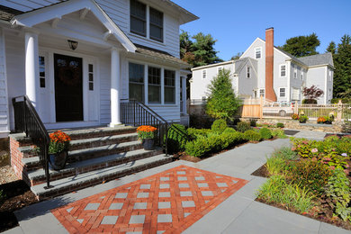 Inspiration for a large traditional full sun front yard stone landscaping in Boston.