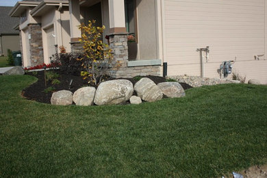 Photo of a traditional front yard concrete paver landscaping in Omaha.