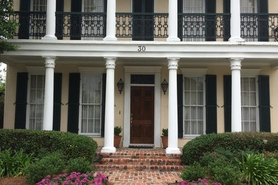 This is an example of a medium sized traditional front garden in New Orleans with brick paving.
