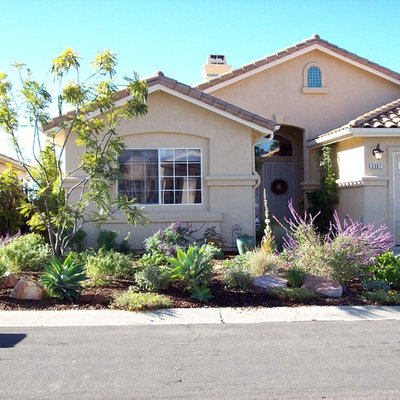 Inspiration for a mid-sized traditional partial sun front yard concrete paver driveway in San Diego.