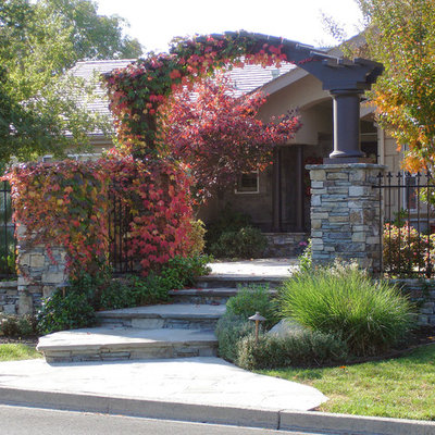Photo of a mid-sized traditional partial sun front yard stone landscaping in San Francisco for fall.