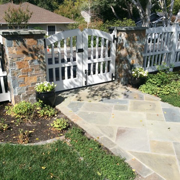 Arched White Fence and Paved Walkway