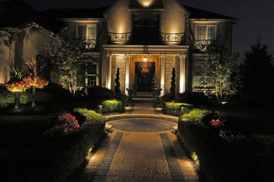 This is an example of a large traditional front yard stone landscaping in Columbus.