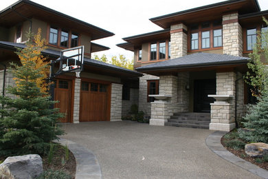 Photo of a large modern full sun front yard stone driveway in Calgary for summer.