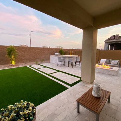 Inspiration for a large contemporary full sun backyard stone and stone fence landscaping in Phoenix.