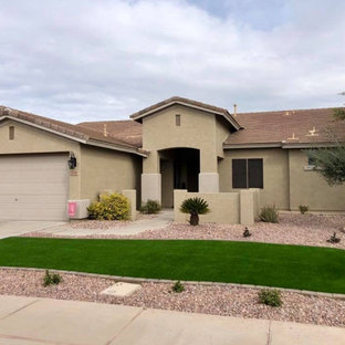 This is an example of a large contemporary full sun front yard stone and stone fence landscaping in Phoenix.