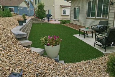 Photo of a mid-sized modern full sun backyard landscaping in Denver.