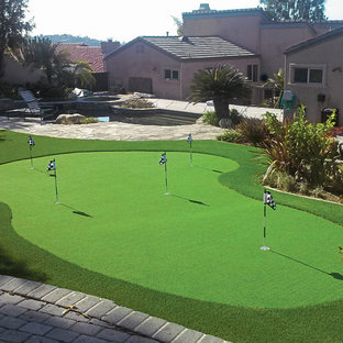 Photo of a large mediterranean full sun backyard stone landscaping in Orange County.