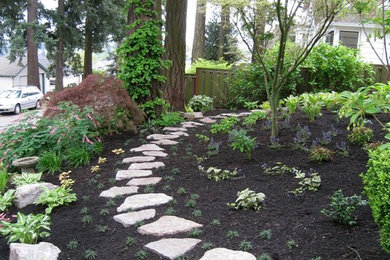 Photo of a mid-sized asian shade front yard stone garden path in Portland for spring.